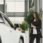Customer receiving a real-time car price estimate in Dubai at AZ Cars showroom