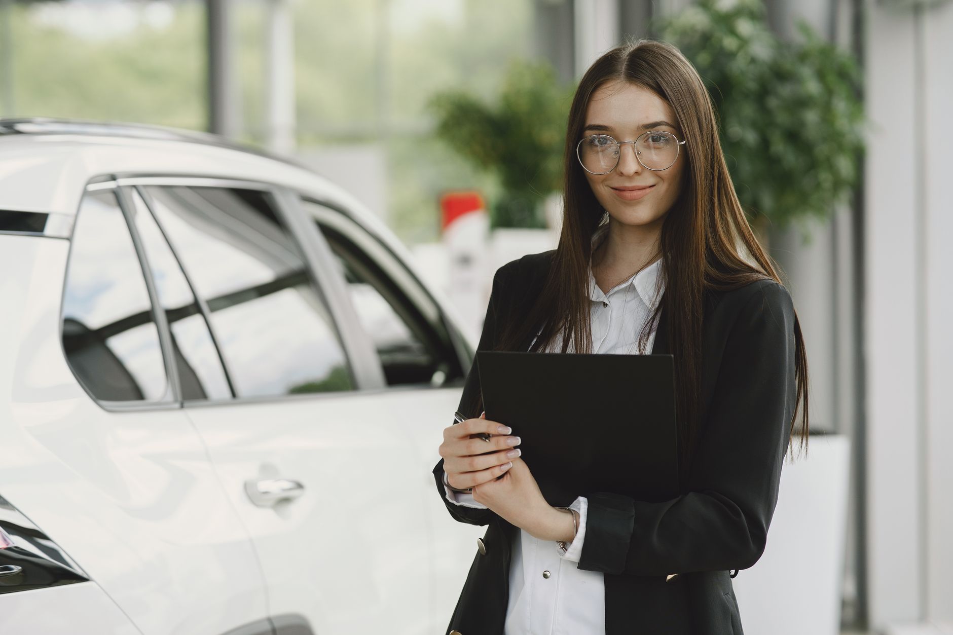 Customer handing over car selling documents in Dubai at a professional dealership
